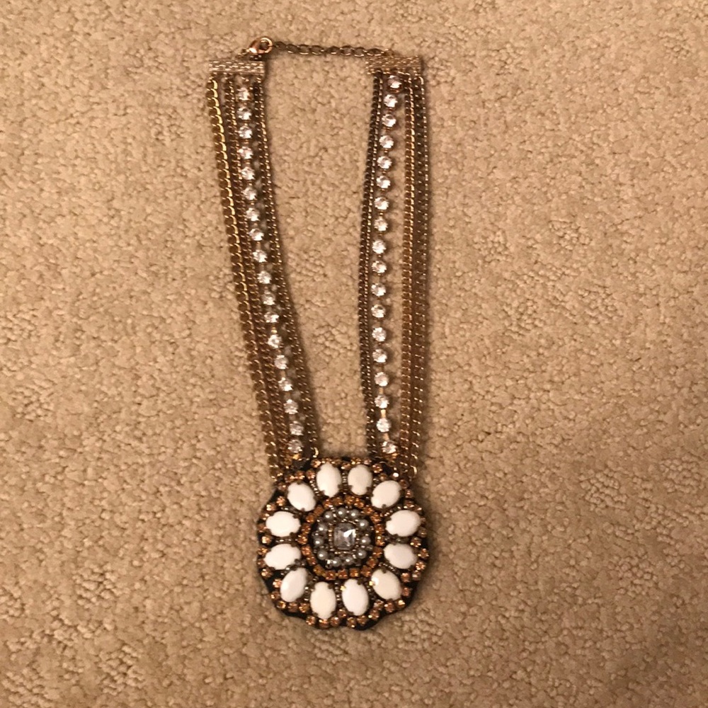 gold necklace with jeweled, detailed pendant